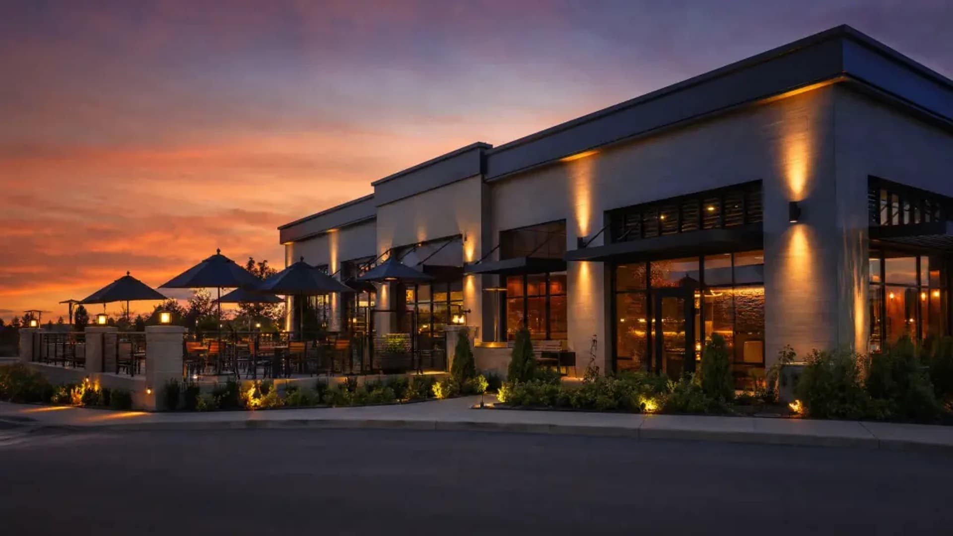 Day-to-dusk — building with facade lighting and a lit entrance at night