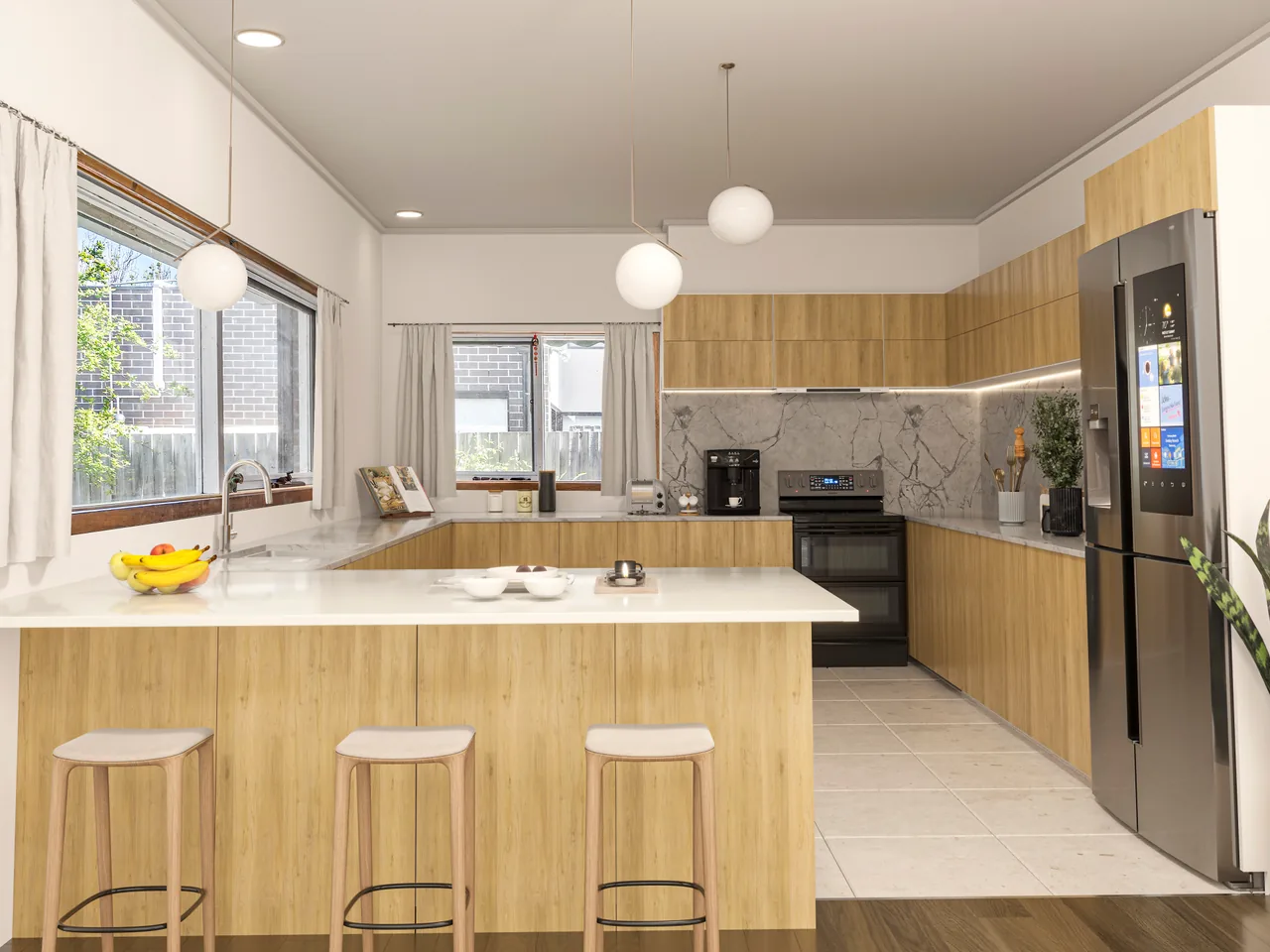 The same kitchen after virtual renovation — modern light cabinets, a marble wall, a white counter and new appliances